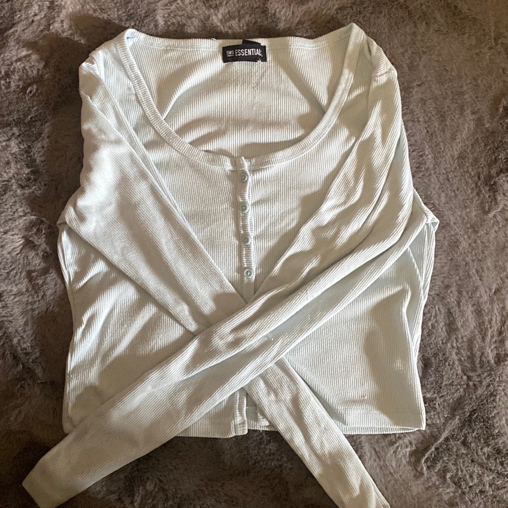 This is a crop too long sleeved and it’s light blue made by sws essentials